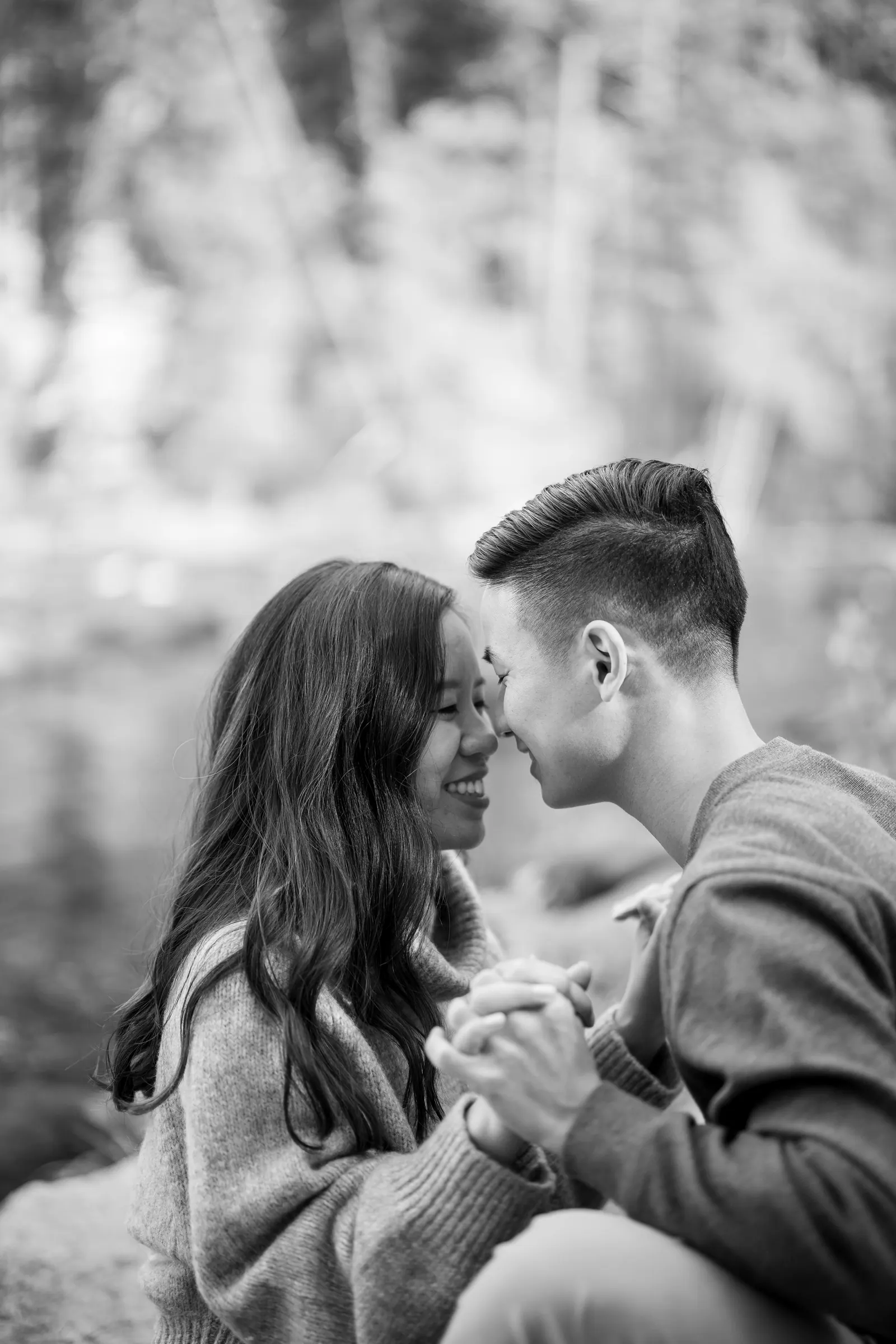 Black and white close-up of an engaged couple embracing