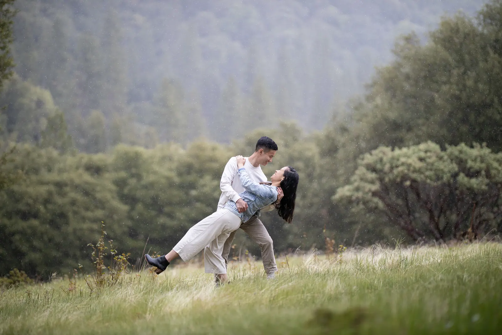 Couple dancing in a misty green meadow