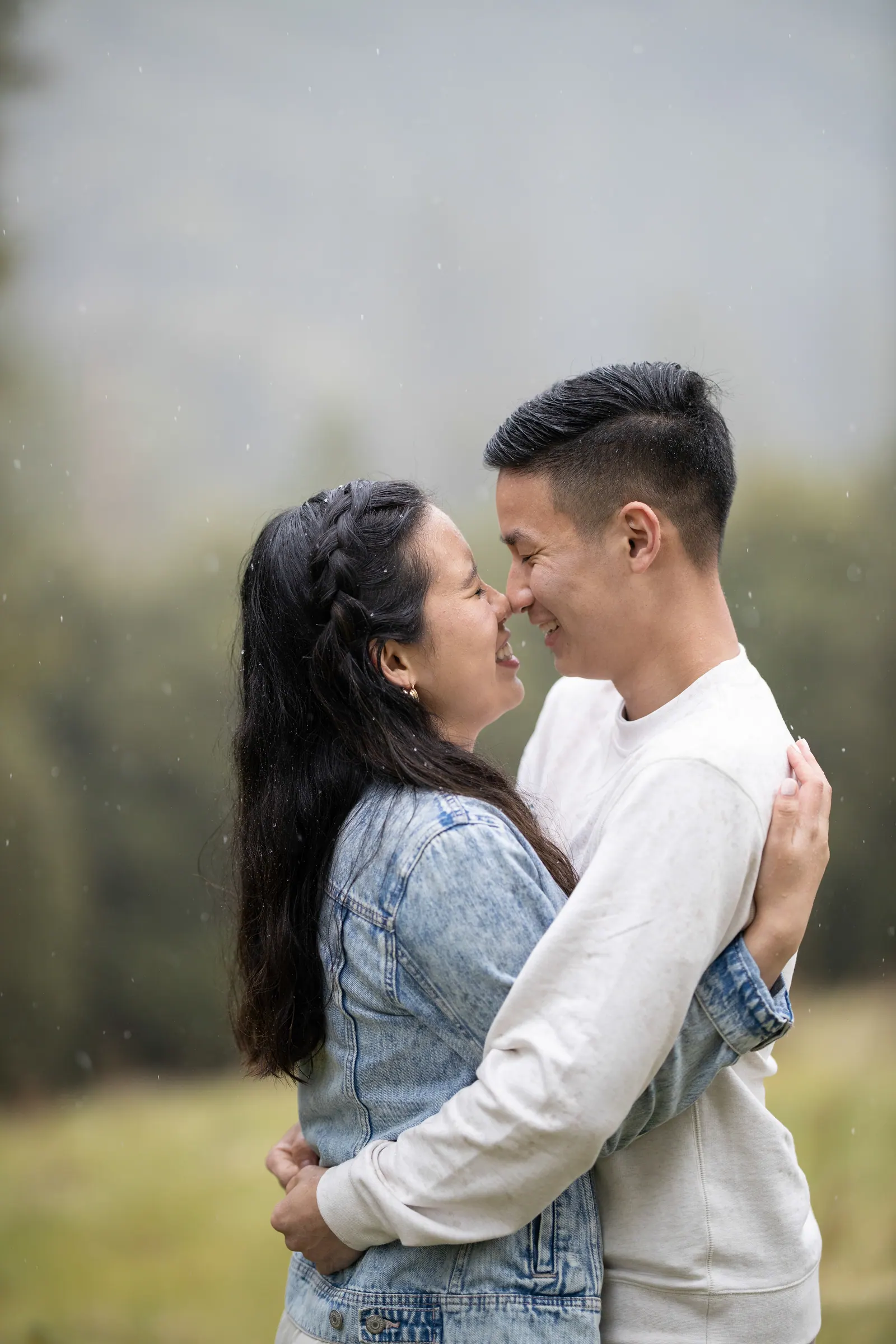 Couple smiling close together in soft light