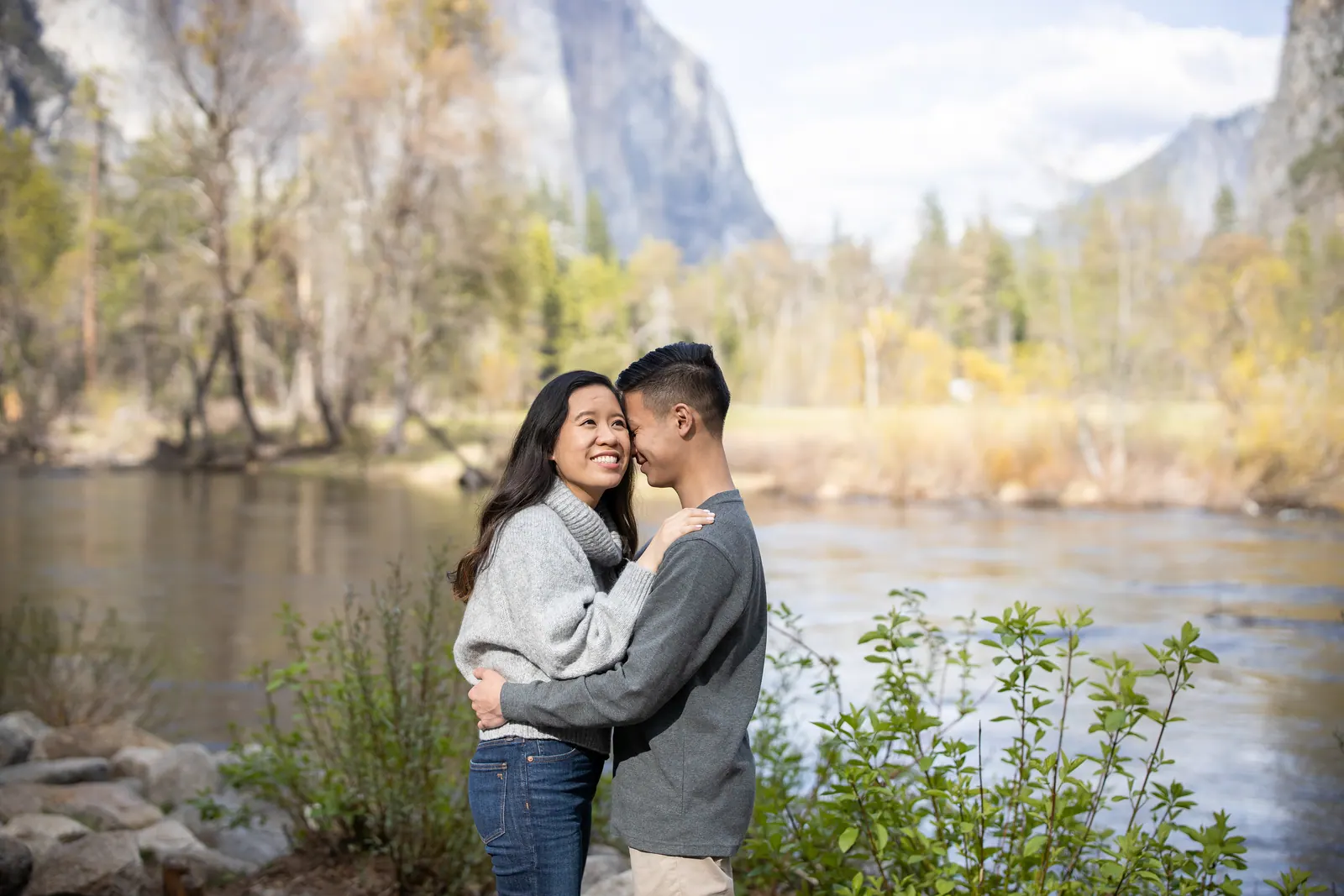 Couple hugging beside a mountain river in Yosemite
