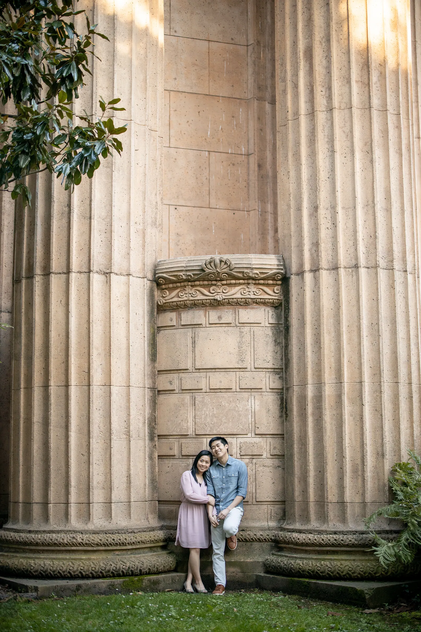 Couple standing between giant columns at the Palace of Fine Arts