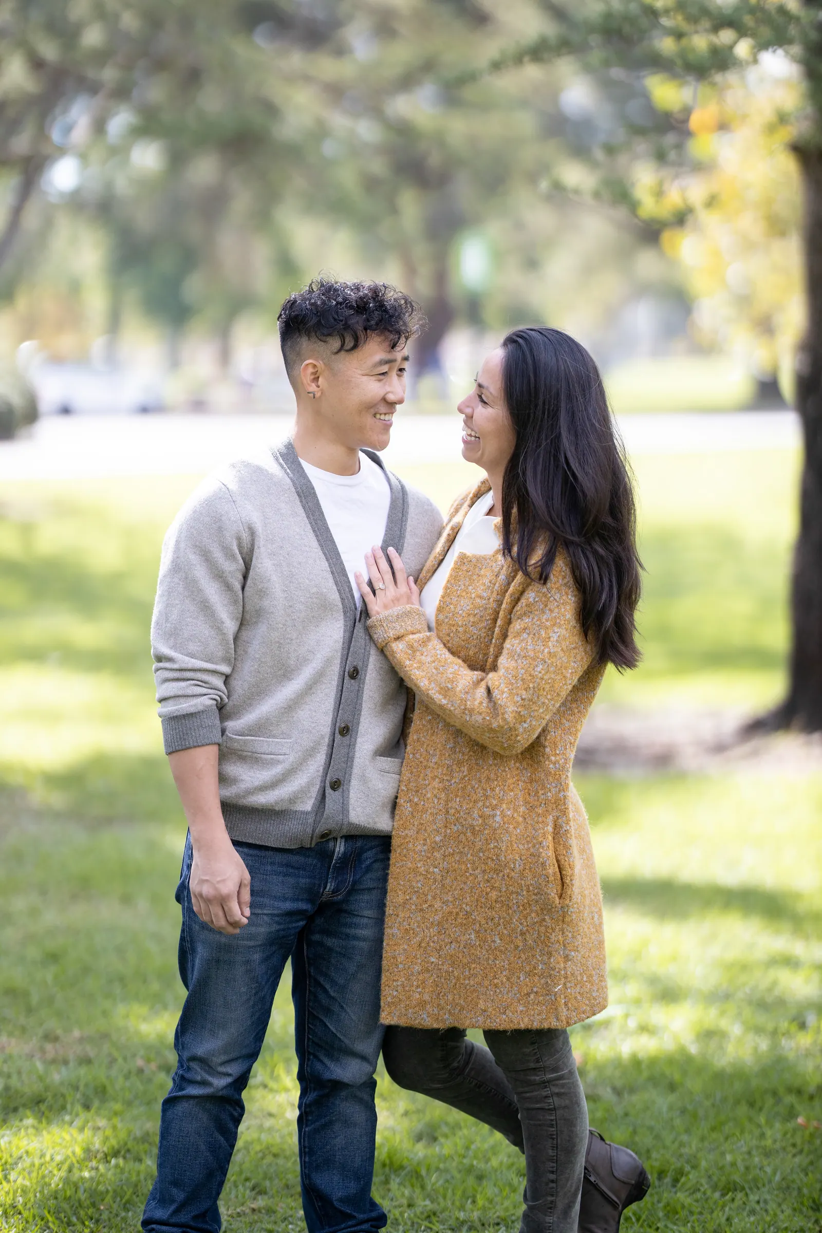 Couple standing close together in a park