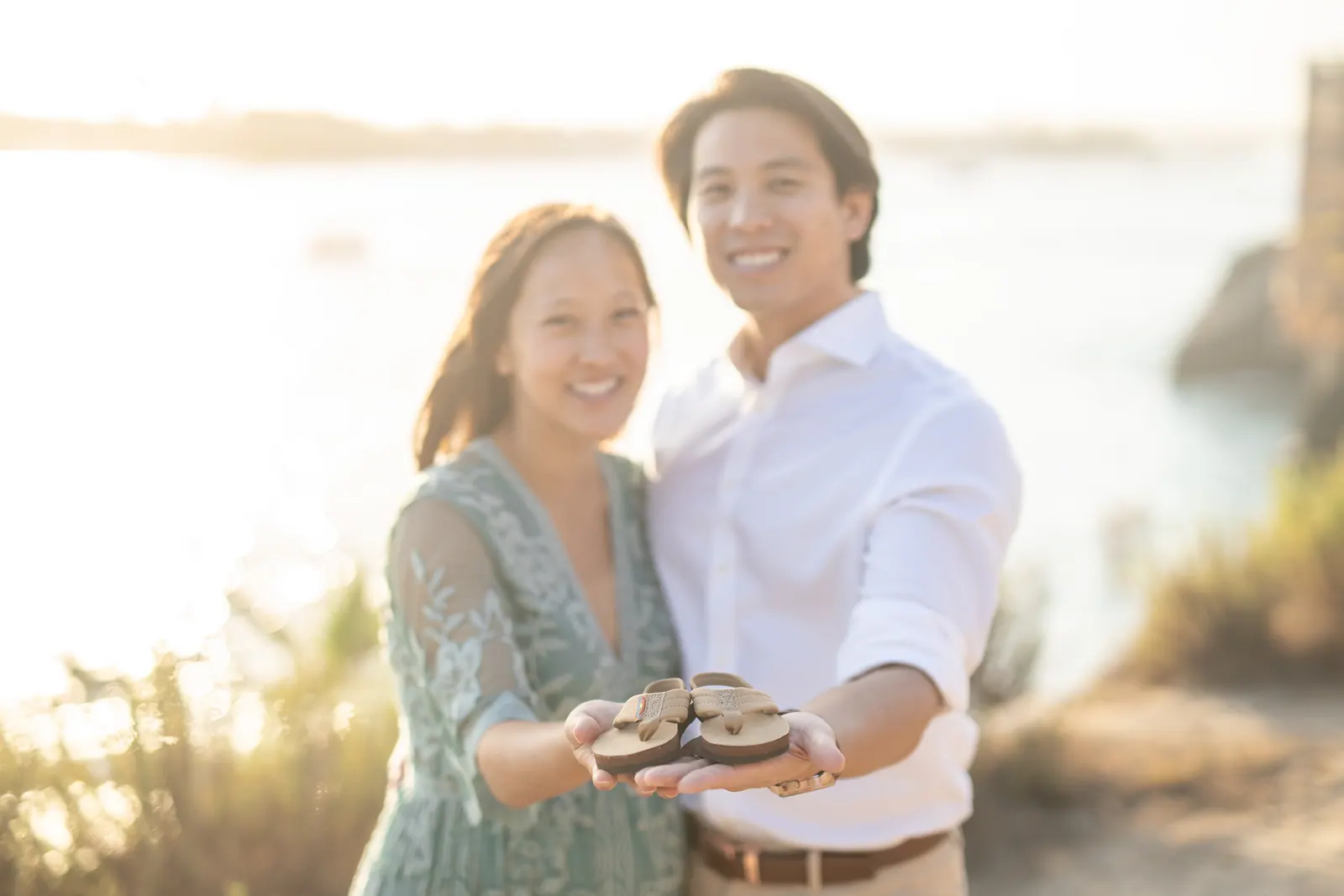 Couple smiling at the beach in golden light