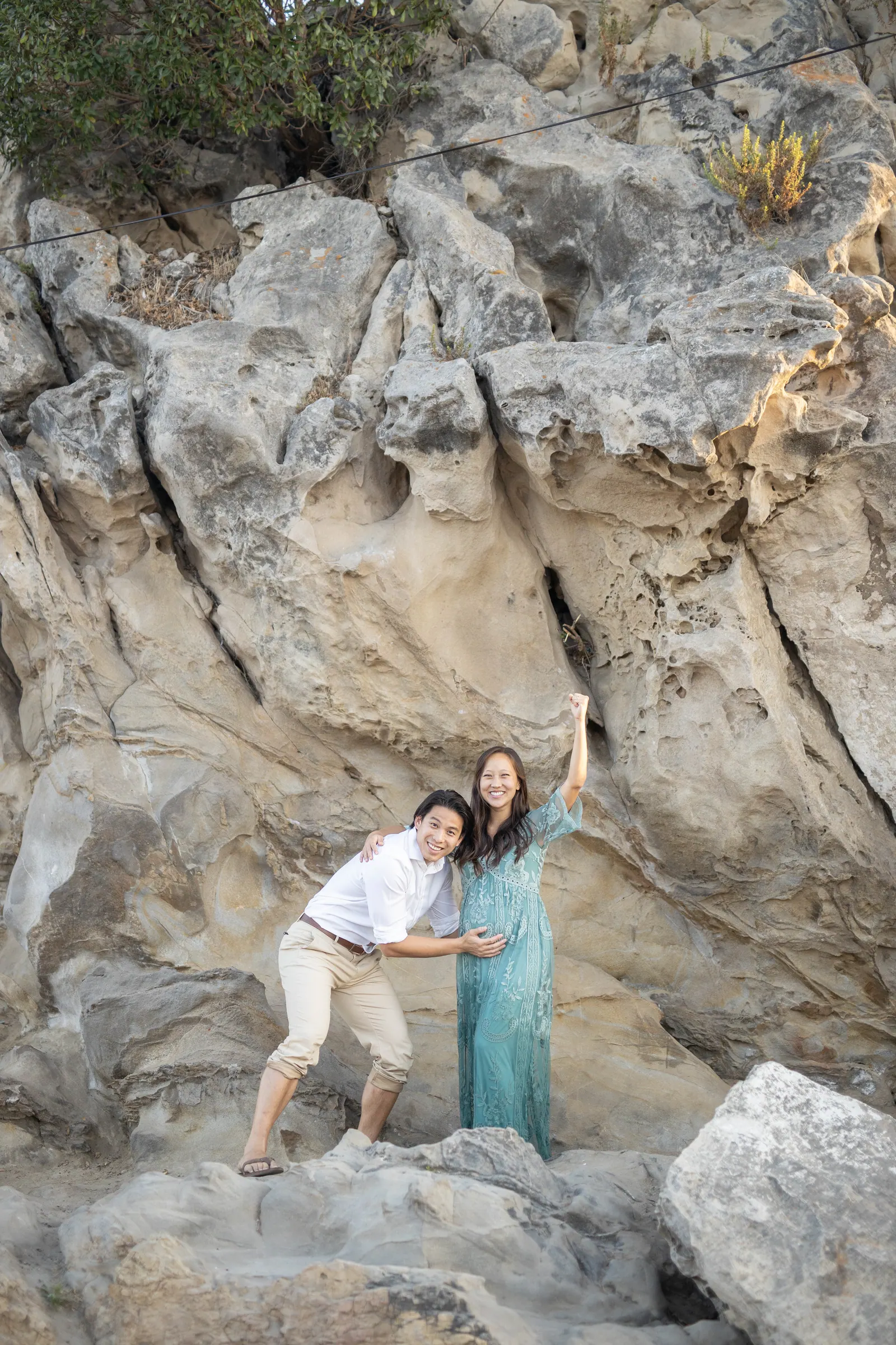 Couple standing among tall sandstone rocks