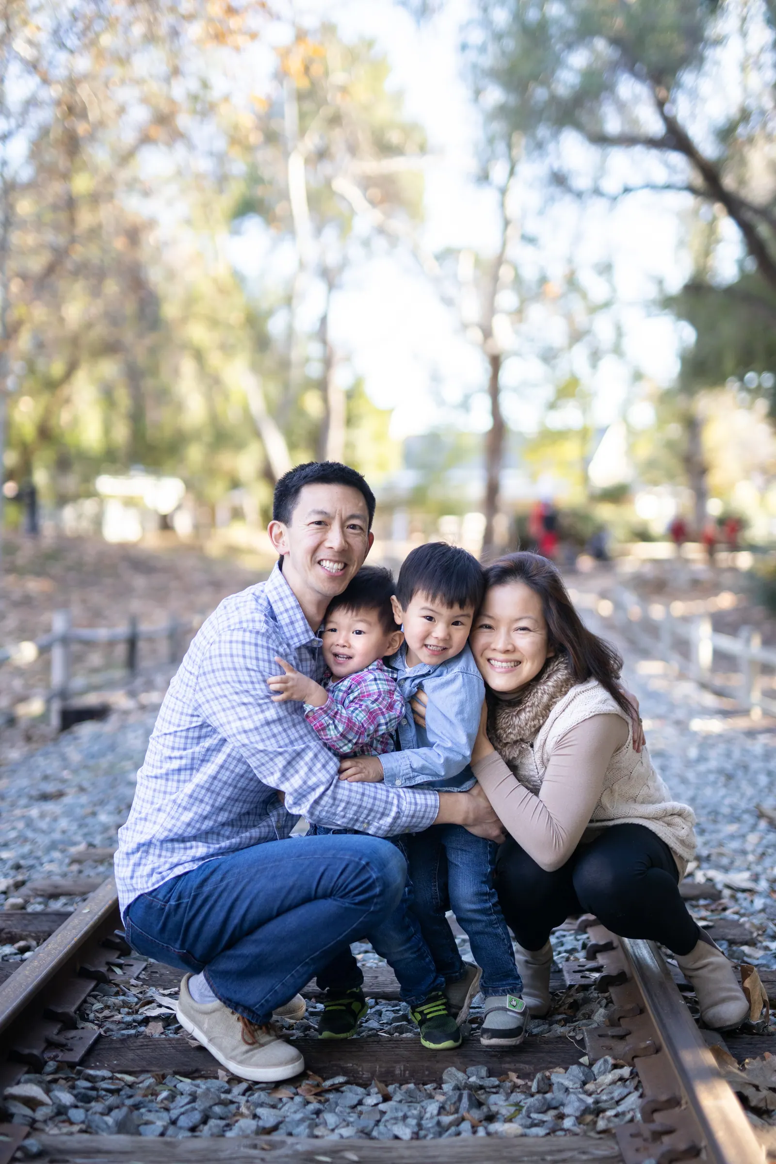 Parents and children sitting on railroad tracks
