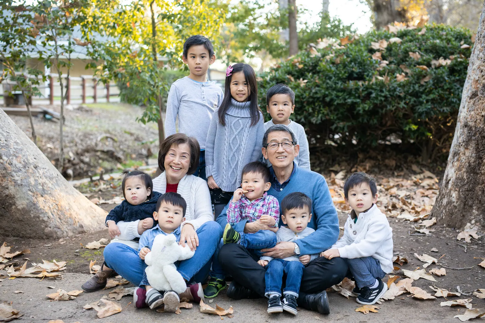 Large extended family gathered on fallen leaves