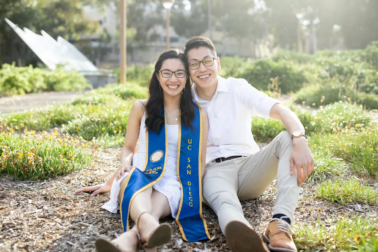 Graduate and partner sitting together in a garden