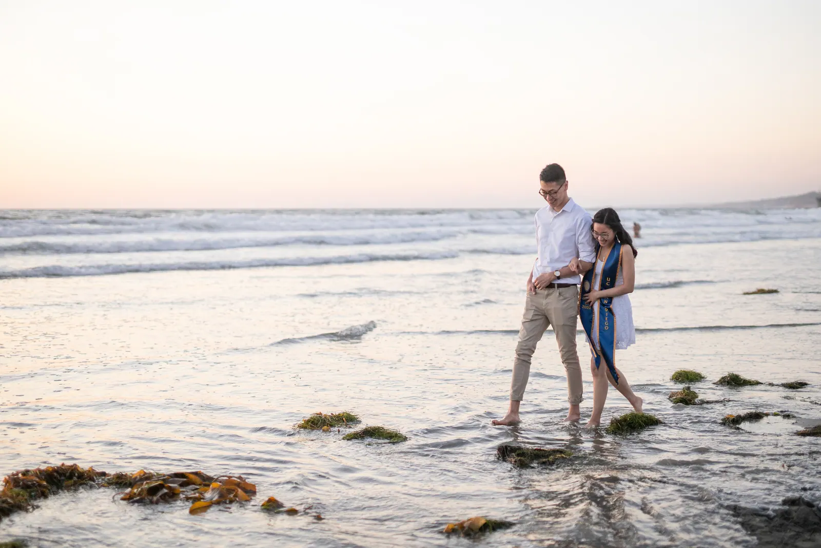 Two people standing in tide pools at the beach