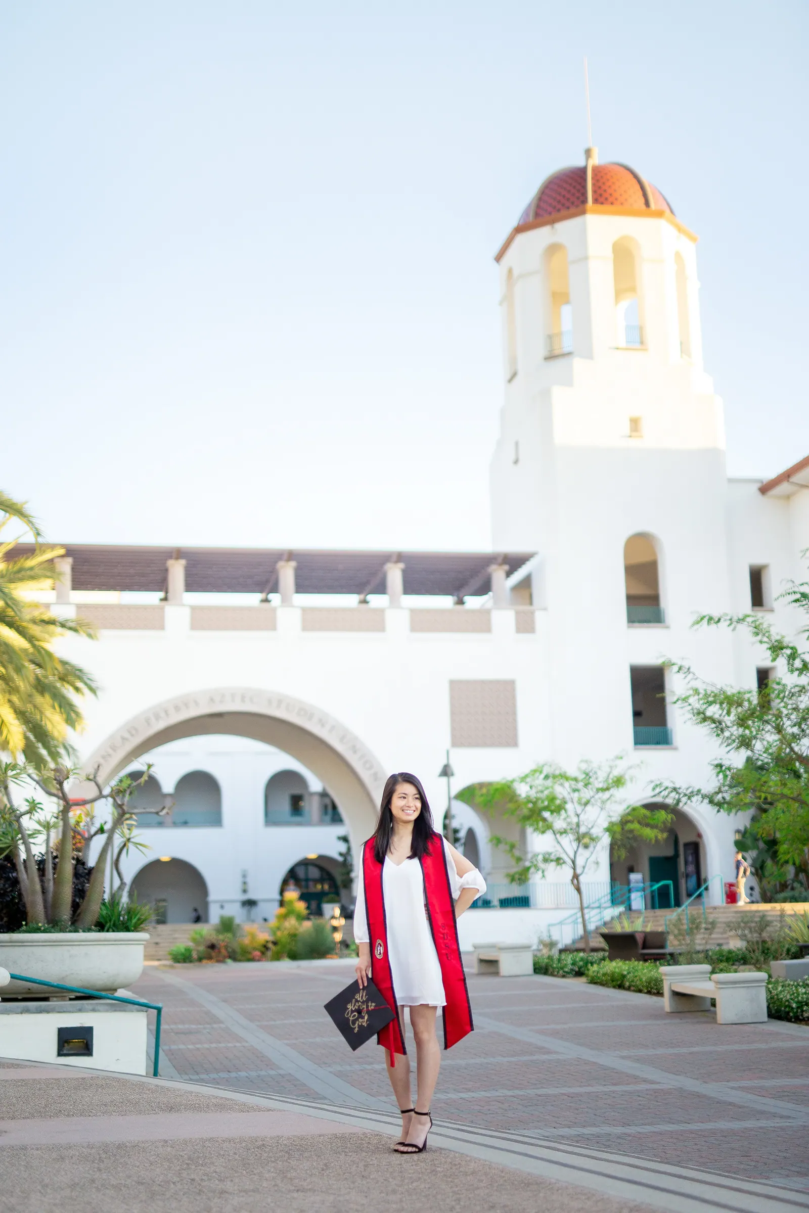 Graduate in front of San Diego State's Hepner Hall bell tower