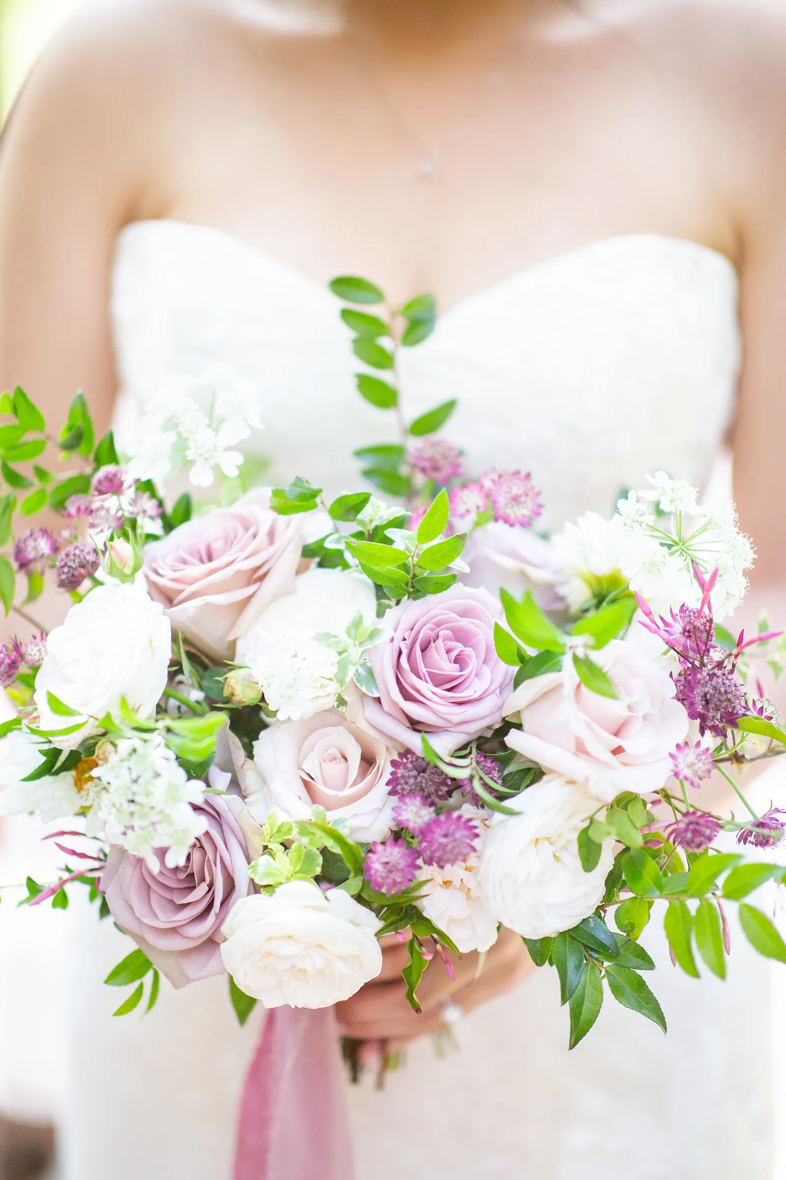 Close-up of the bride's pink and white rose bouquet