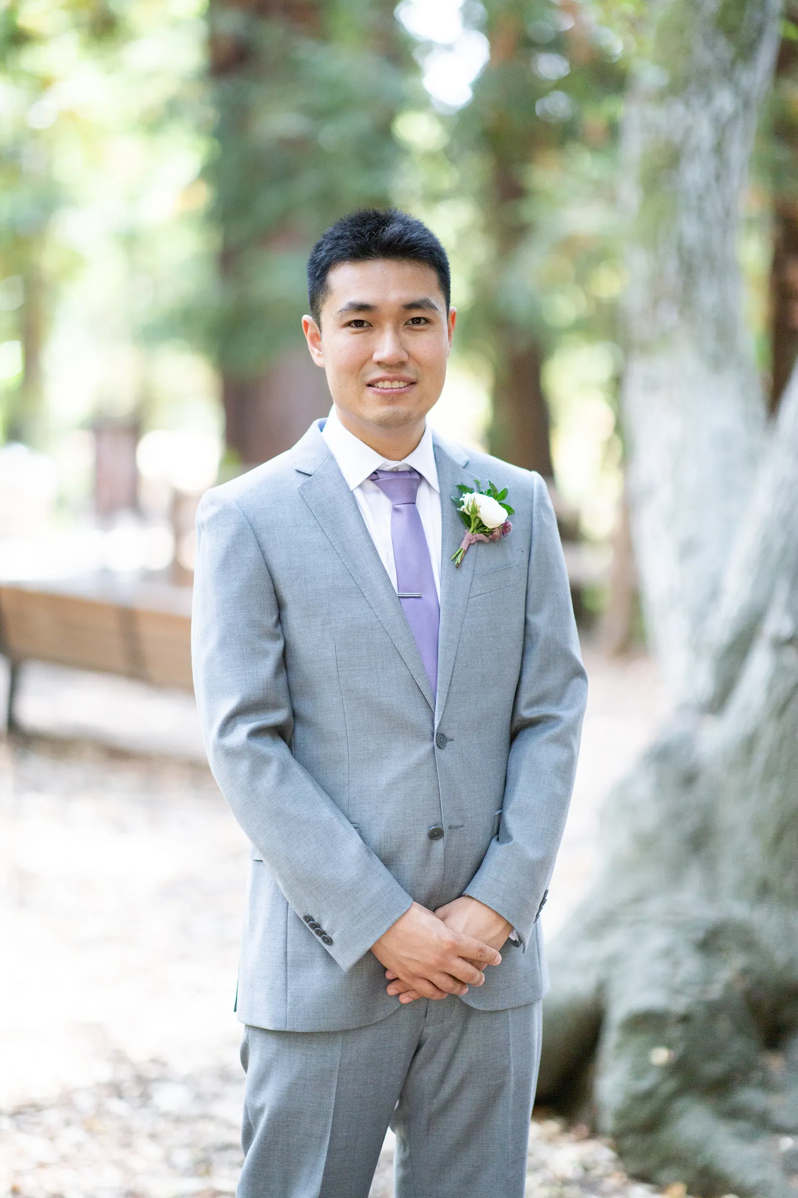 Groomsman in a grey suit with boutonniere